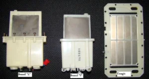 Three different water ionizer plate assemblies labeled as Brand "L", Brand "T", and Enagic are displayed side by side on a dark surface.