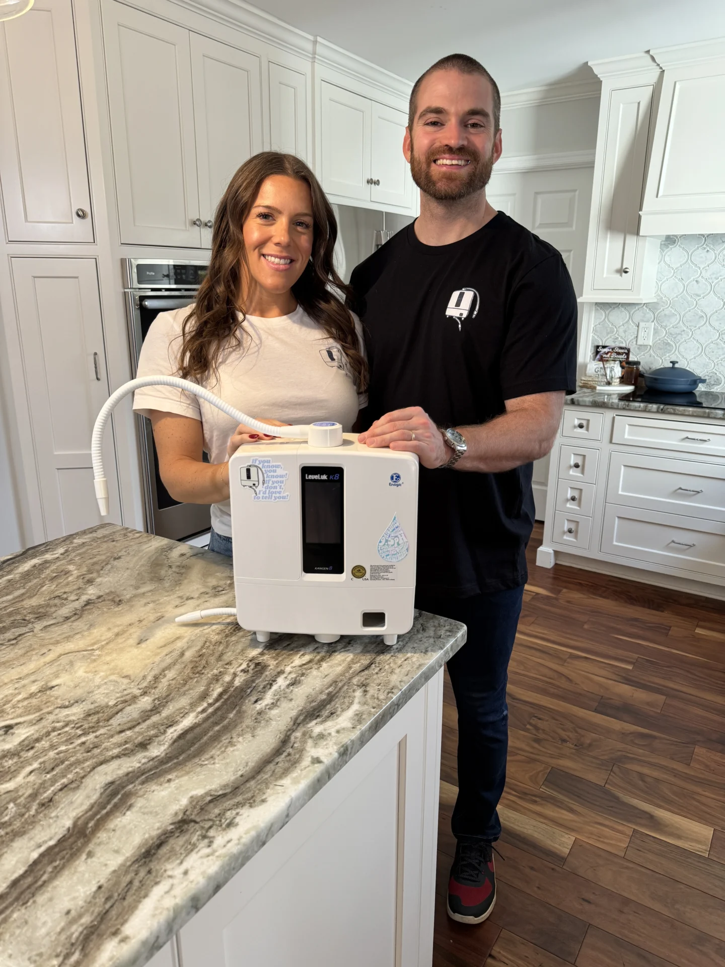 The Kangen Couple with their Enagic Kangen K8 machine on a counter